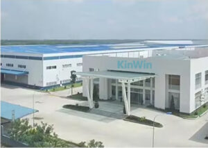 Modern KinWin plush toy manufacturing facility with white exterior and blue roof.
