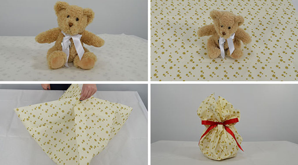 Step-by-step guide showing a teddy bear being wrapped in patterned fabric and tied with a red ribbon for gift presentation.