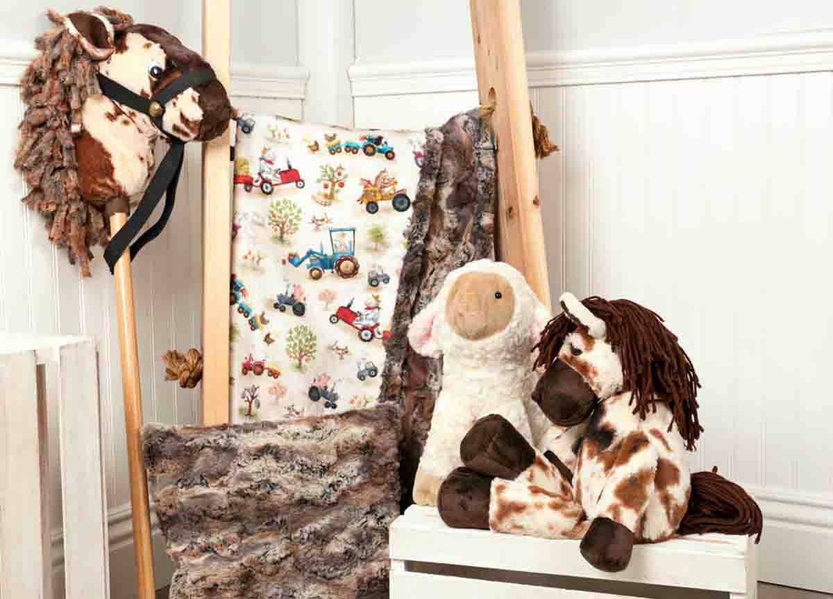 Plush horse and sheep toys displayed with faux fur fabrics and a hobby horse, showcasing realistic textures for toy making.