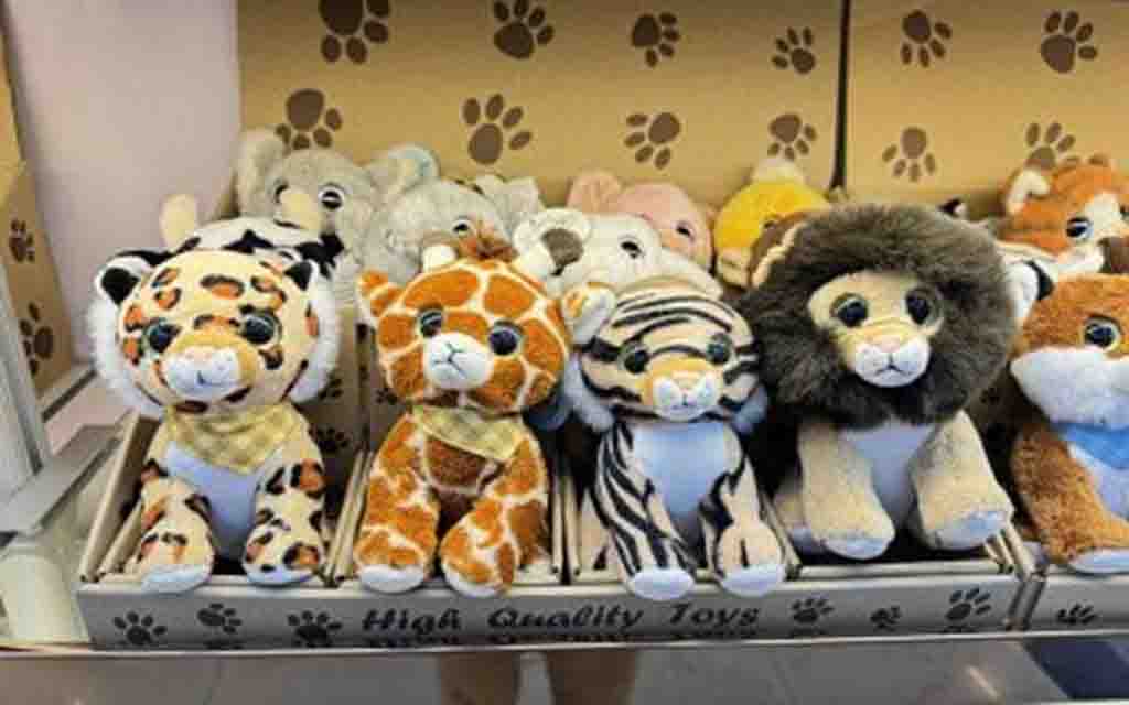 Plush toys of jungle animals including tiger, giraffe, zebra, and lion displayed in a toy store box labeled "High Quality Toys."
