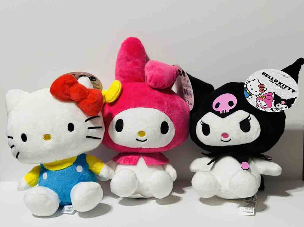 Sanrio plush toys featuring Hello Kitty, My Melody in pink, and Kuromi in black with skull design.