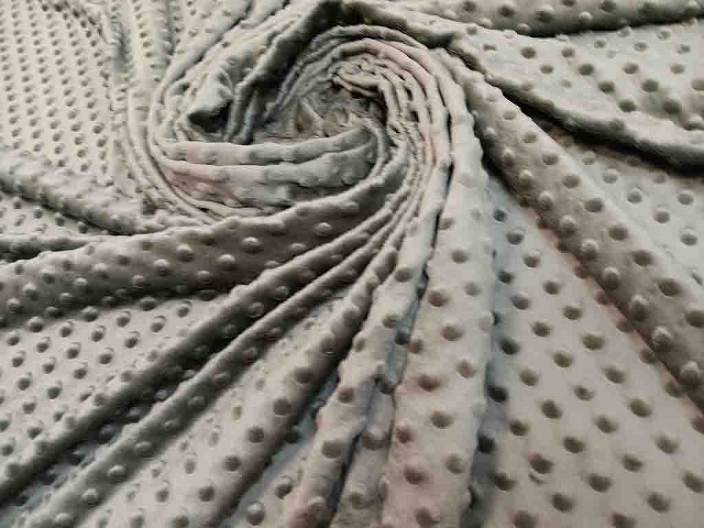 Ultra-soft gray minky fabric with raised dot texture, perfect for plush toys, blankets, and baby products.