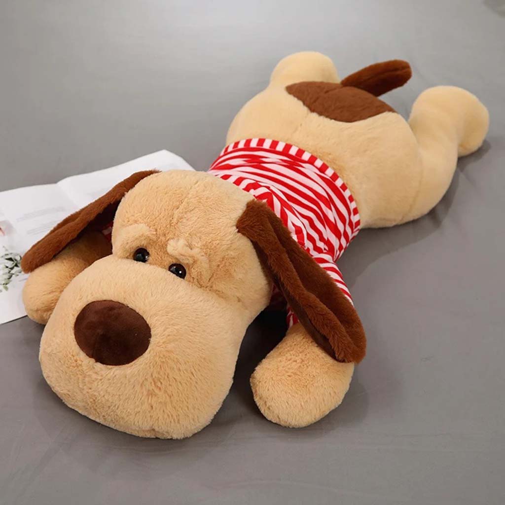 Large stuffed dog plush lying flat, wearing a red and white striped shirt with brown floppy ears and a cute face.