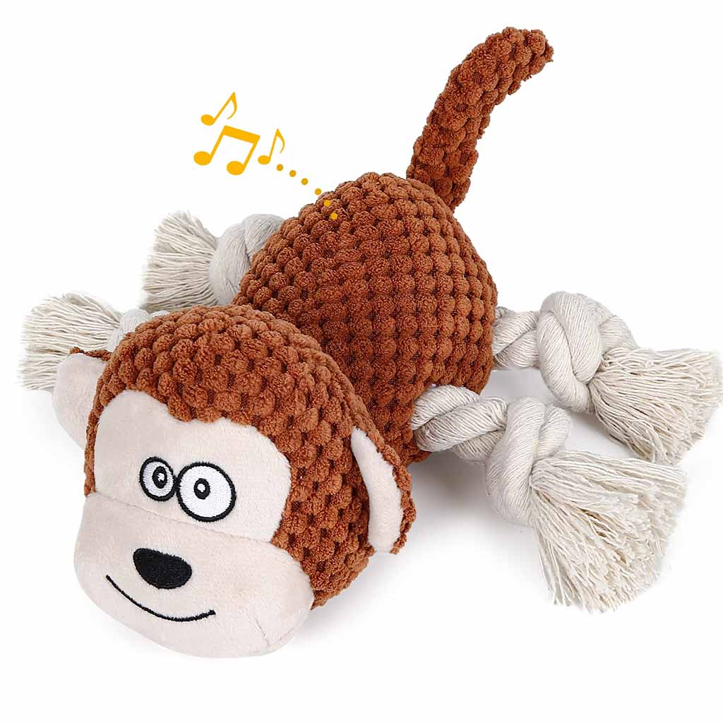 Brown plush monkey dog toy featuring knotted rope arms and tail, soft textured fabric, and a built-in squeaker indicated by music notes.