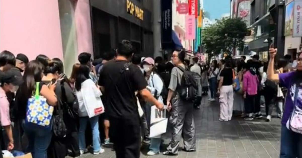 Large crowd of people waiting in line outside a Pop Mart store, showing the popularity of collectible toys and blind box trends.