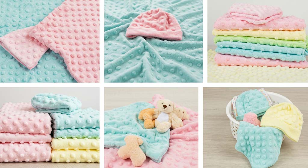 Assorted pastel-colored minky dot fabrics and baby blankets with plush toys and accessories displayed in cozy settings.