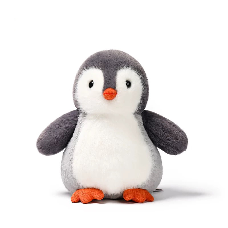 Cute grey and white penguin plush toy with an orange beak and feet, soft rounded body, and friendly expression, displayed on a white background.