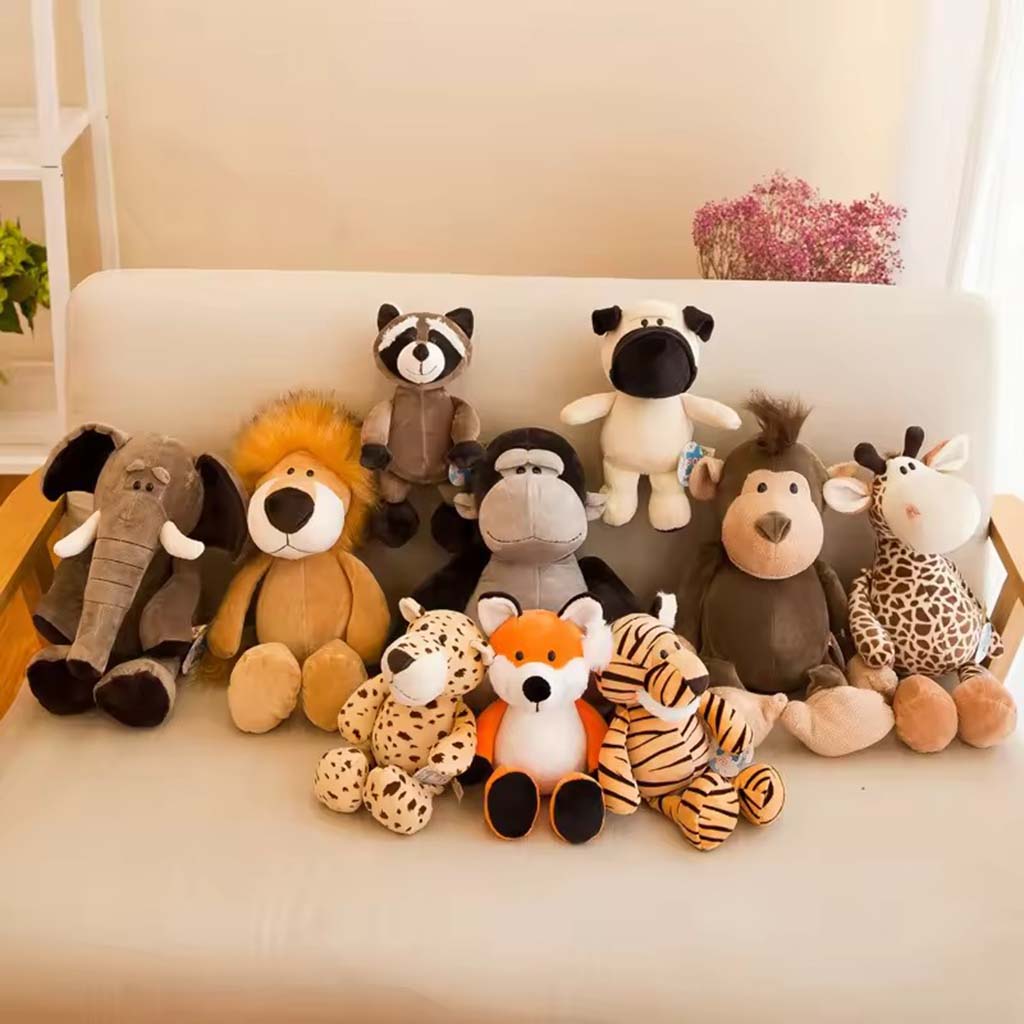A set of cute animal plush toys including an elephant, lion, raccoon, fox, tiger, and giraffe arranged neatly on a white sofa.