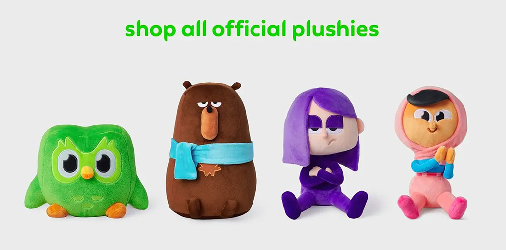 Four colorful character plush toys, including a green owl and various cartoon figures, displayed under the text “shop all official plushies.”