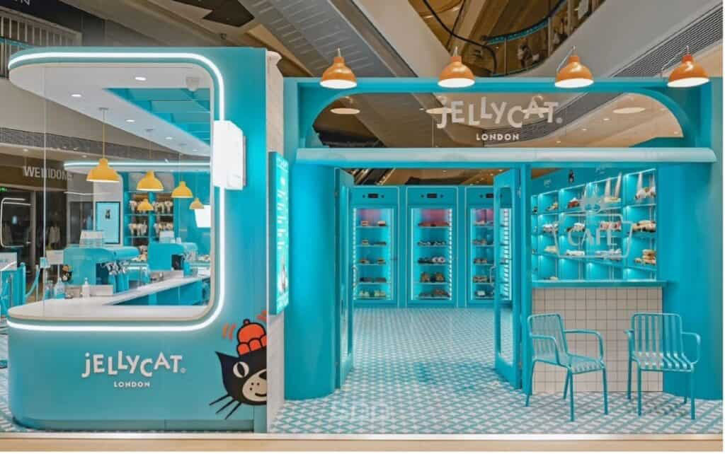 Bright turquoise Jellycat London store interior with plush displays, café seating, and signature brand decor.
