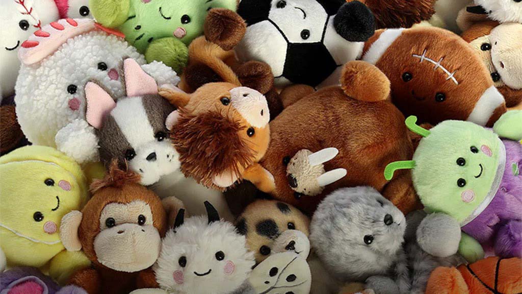 A colorful mix of Aurora World plush toys featuring animals, food characters, and fantasy creatures with smiling faces.