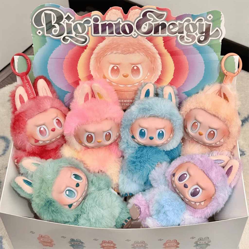 A display box of colorful bunny-themed plush figures with expressive faces, fluffy fur, and big eyes under the label “Big into Energy.”