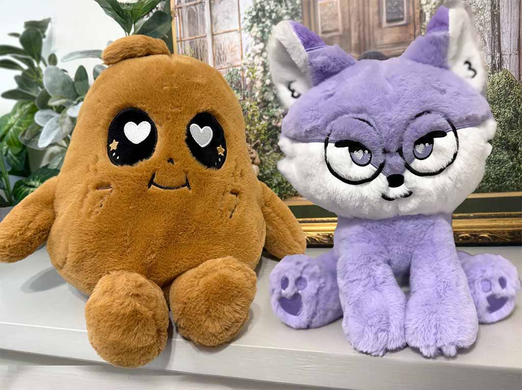 Two plush toys on display — a brown character with heart eyes and a purple fox with glasses and embroidered paw prints.