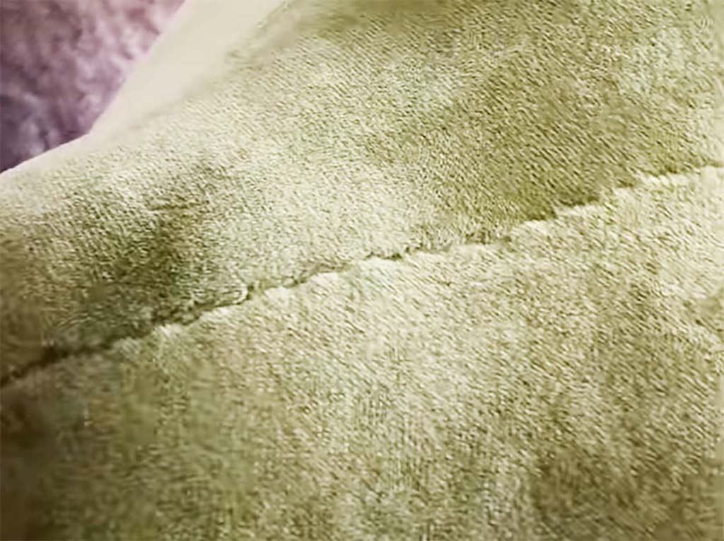Close-up of a plush toy’s soft fabric surface showing the hidden stitch seam method used in manufacturing for smooth finishing and durability.