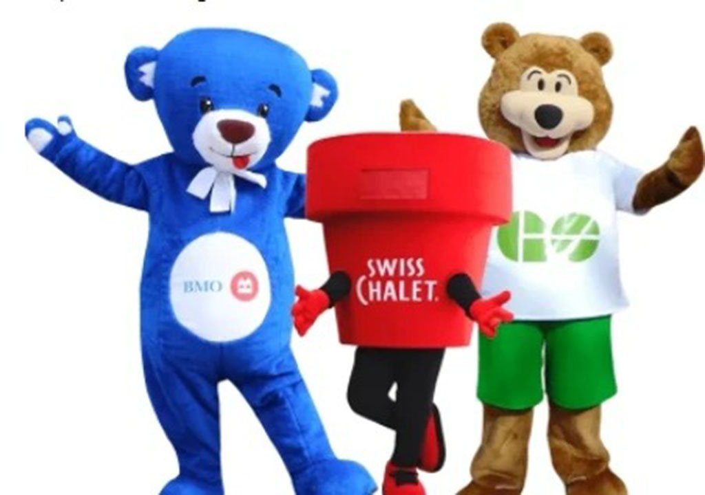 Three colorful mascot costumes posing together, including a blue bear, a red cup-shaped character, and a brown bear in branded clothing.