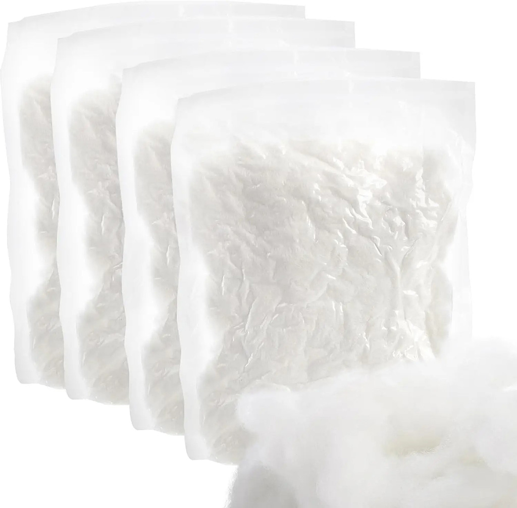 Compressed vacuum-sealed bags of white polyester stuffing fiber for plush toy filling, showing efficient packaging for bulk shipping.