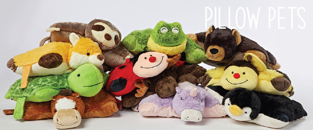 A colorful pile of Pillow Pets plush toys including animals like a frog, turtle, unicorn, penguin, and ladybug, designed as cuddly pillows.