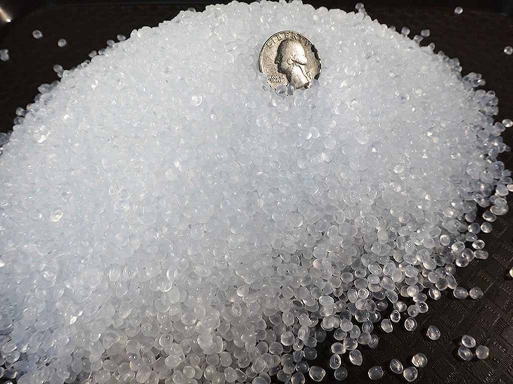 Close-up of transparent plastic pellets used as weighted filling for stuffed animals and plush toys.