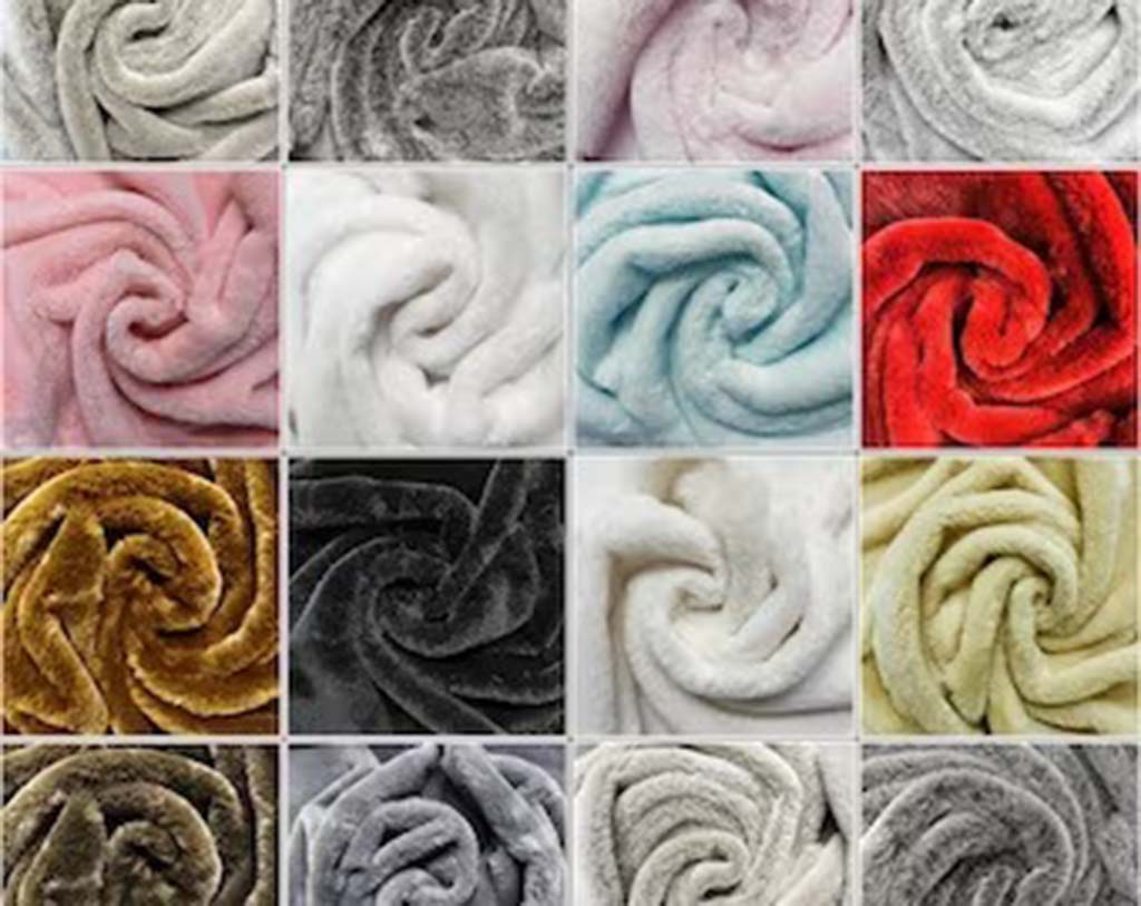 Collection of soft minky fabric samples in various colors including pink, red, white, gray, and gold arranged in swirl patterns.