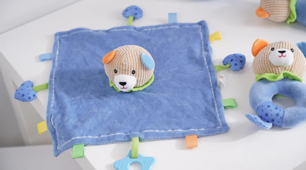Soft blue baby comforter with a plush dog head and matching rattle toy made of minky and corduroy fabrics.