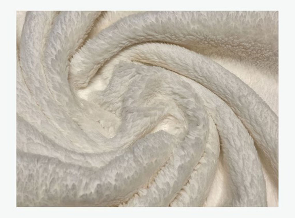 Close-up of soft white plush fabric with a fluffy texture, ideal for making teddy bears and stuffed animals.