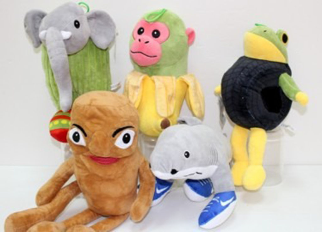 Collection of five quirky plush toys including an elephant, monkey, frog, shark wearing sneakers, and a brown character with long arms, displayed against a white background.