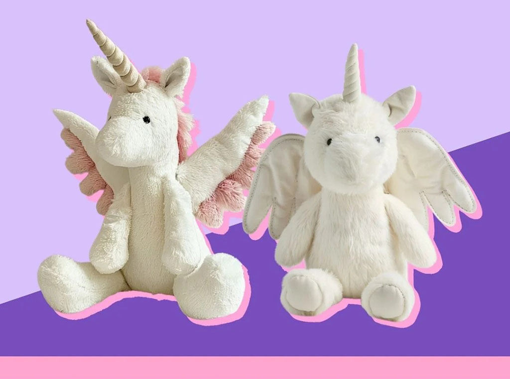 Two soft unicorn plush toys with wings and horns, one with pink accents and the other all white, displayed against a pastel purple background.