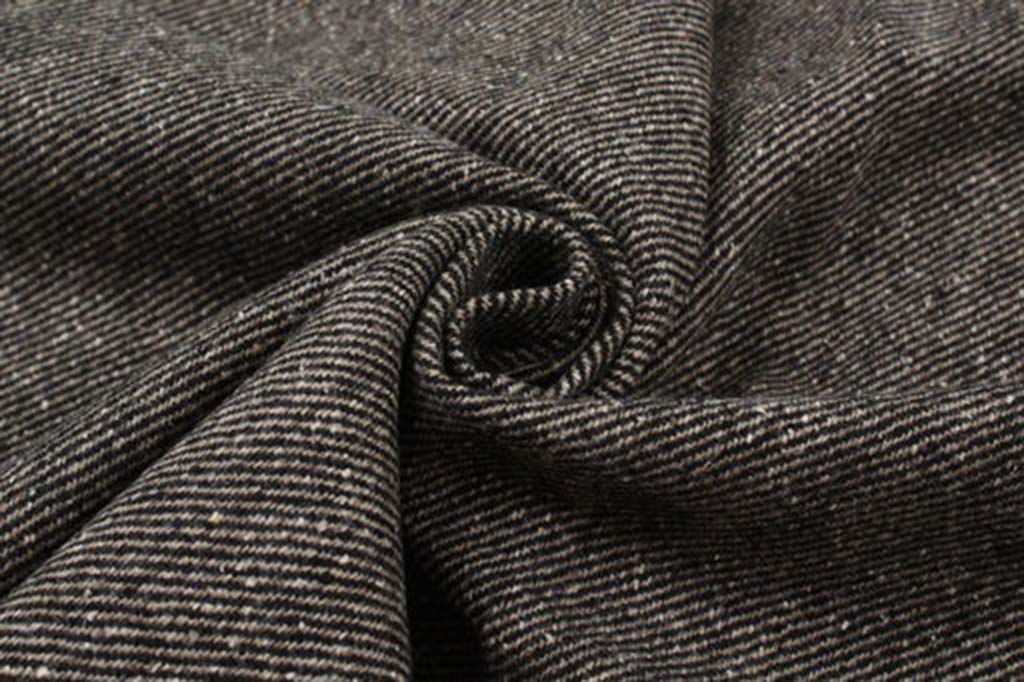 Close-up view of brown and black bi-color recycled wool twill fabric showing its fine striped texture and soft drape.
