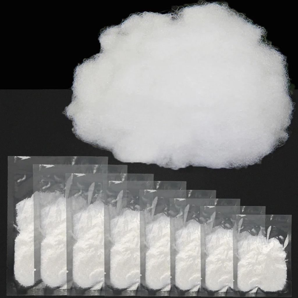 High-elastic polyester fiberfill shown loose and in small sealed packets, used as soft, lightweight stuffing for plush toys and handmade crafts.