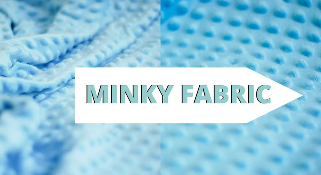 Close-up of soft blue minky fabric showing its dotted texture, commonly used in plush toys and baby products.