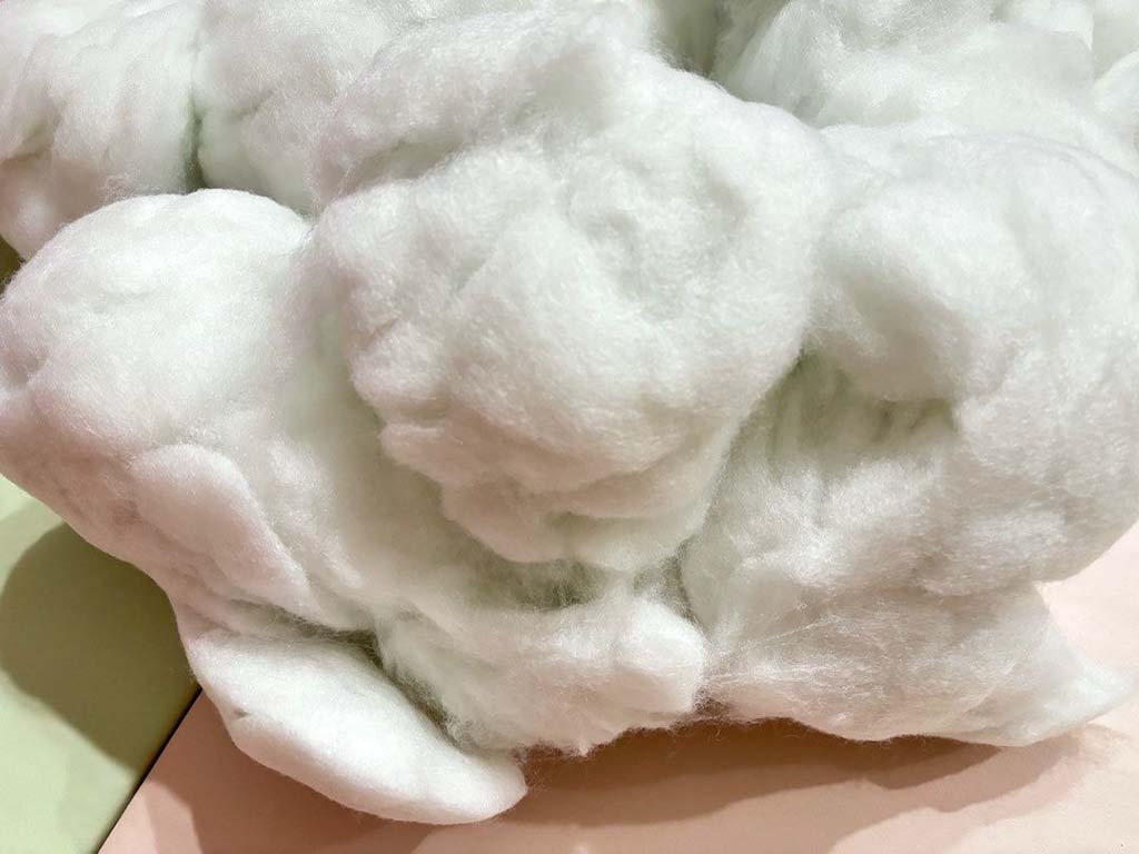 Fluffy white polyester fiberfill used as soft, lightweight stuffing for plush toys, pillows, and handmade crafts.