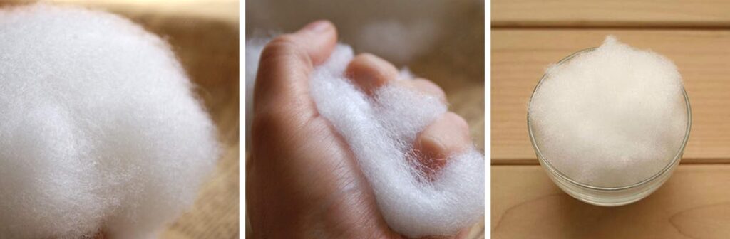 Soft white polyester fiberfill shown in hand and bowl, commonly used as stuffing material for plush toys and cushions.