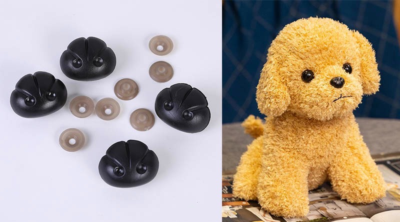 Close-up of black plastic safety noses with washers next to a plush toy dog showing how the nose parts are used in stuffed animal manufacturing.