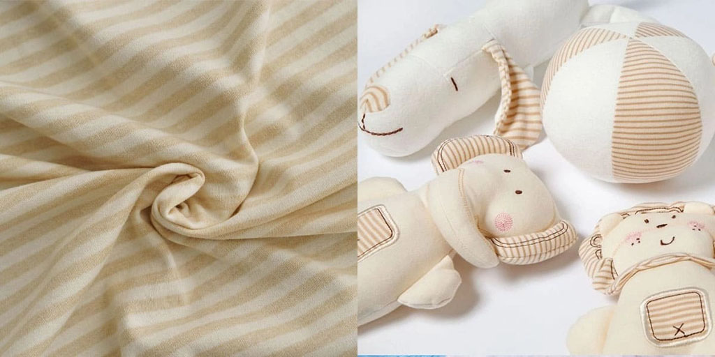 Beige striped organic cotton fabric and soft baby plush toys made from the same gentle material, showing safe and natural textile use for infants.