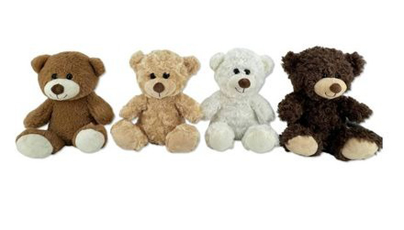 A row of four plush teddy bears in different shades of brown, beige, white, and dark brown, sitting upright against a white background.