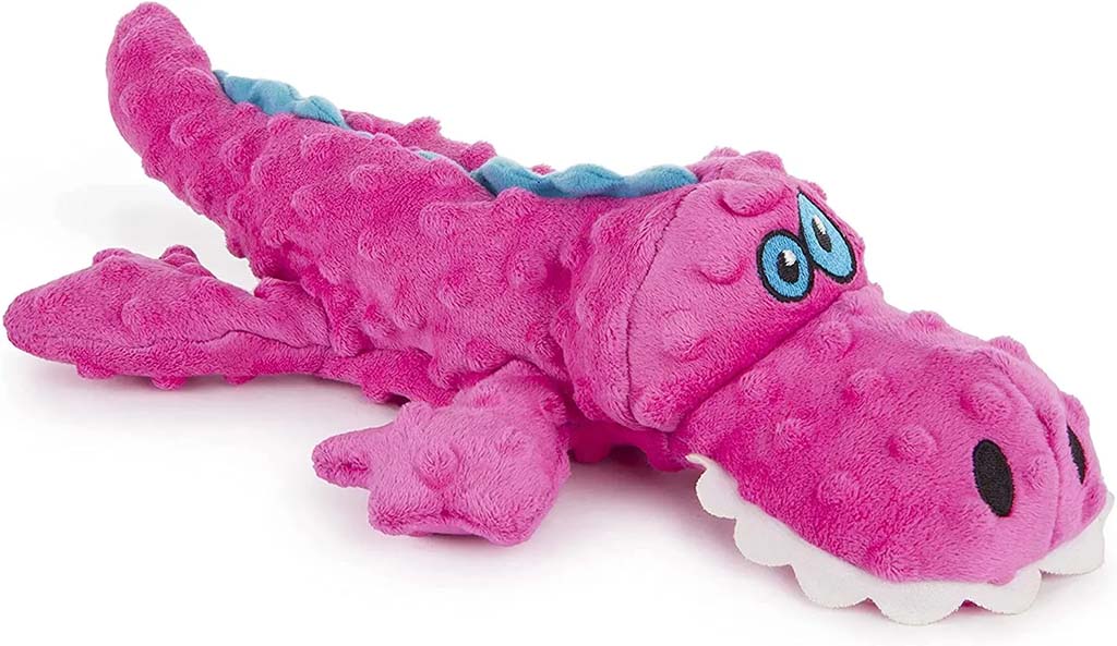 Bright pink alligator plush toy with textured minky fabric, embroidered eyes, and a soft, friendly expression.