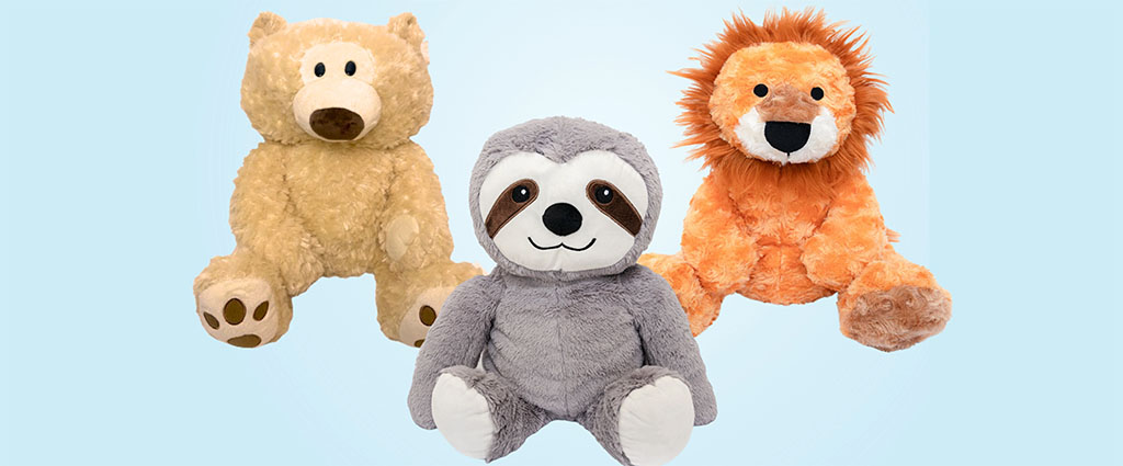 Three soft stuffed animals — a beige bear, gray sloth, and orange lion — sitting upright against a light blue background.