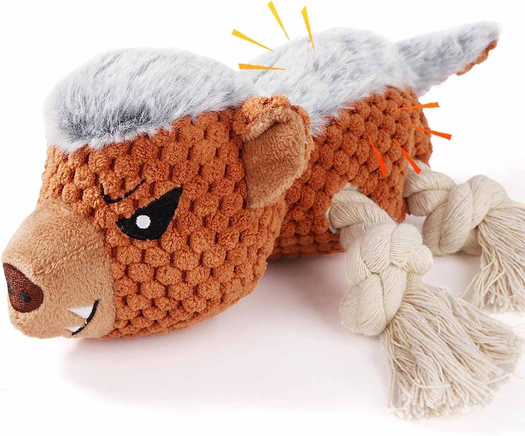 Close-up of a tough plush dog toy designed like an angry animal, featuring textured fabric, gray faux fur on its back, and sturdy rope legs for chewing.
