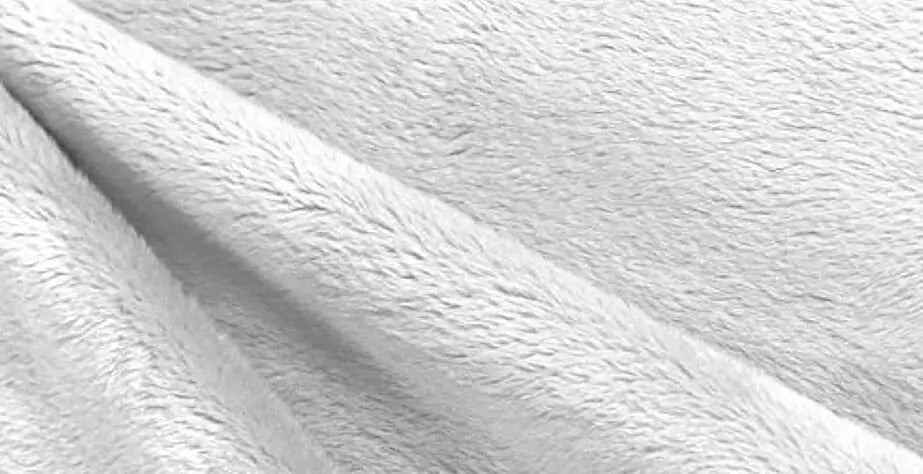 Close-up view of a soft, short-pile plush fabric in a light color, showing its smooth, velvety surface commonly used for stuffed animals and plush toys.