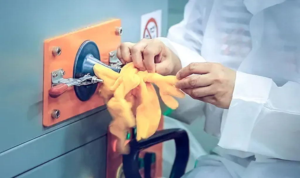 Worker using an automatic stuffing machine to fill a plush toy limb with fiber stuffing, demonstrating factory-level production in plush toy manufacturing.