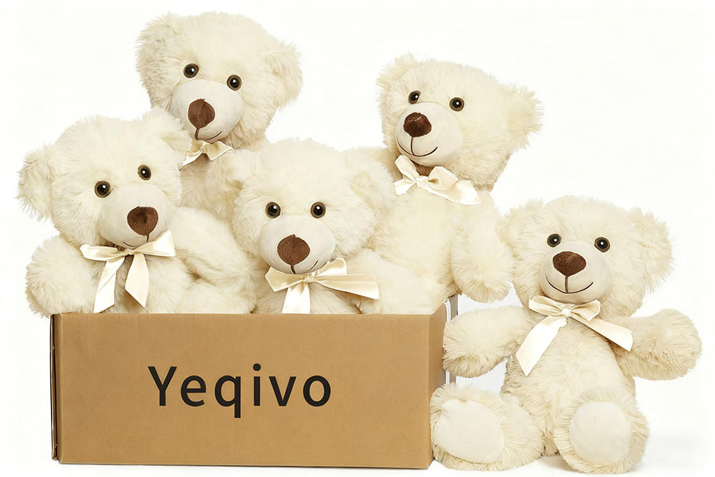 A group of fluffy white teddy bears with cream ribbon bows sitting together inside and around a cardboard box labeled “Yeqivo,” against a clean white background.