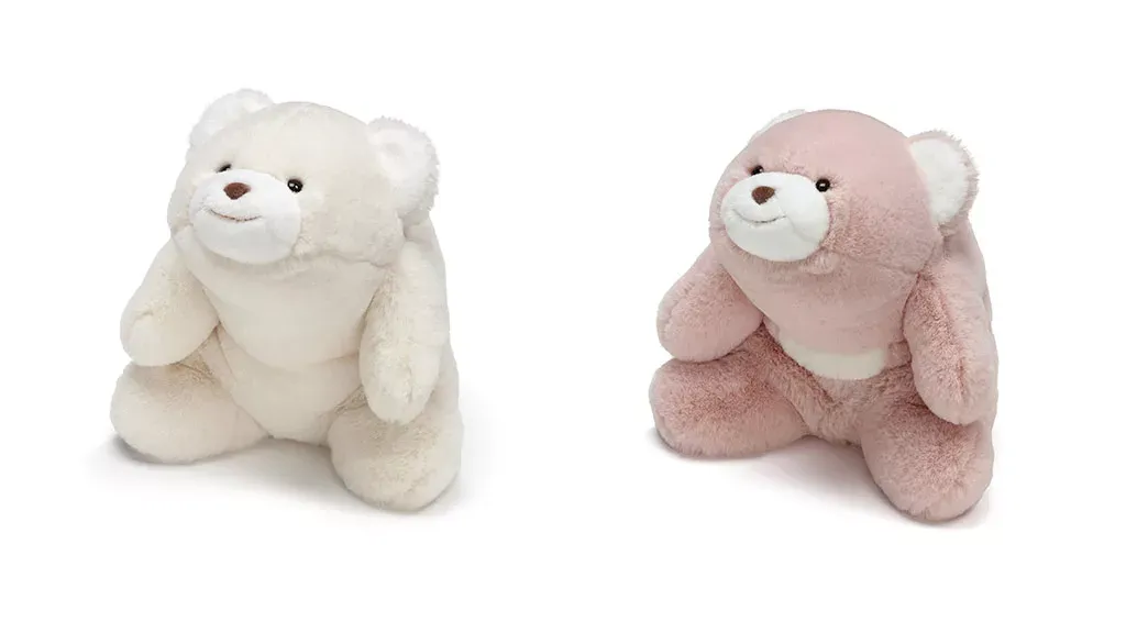 Two soft teddy bears in white and pink sitting side by side, made with fluffy plush fabric.