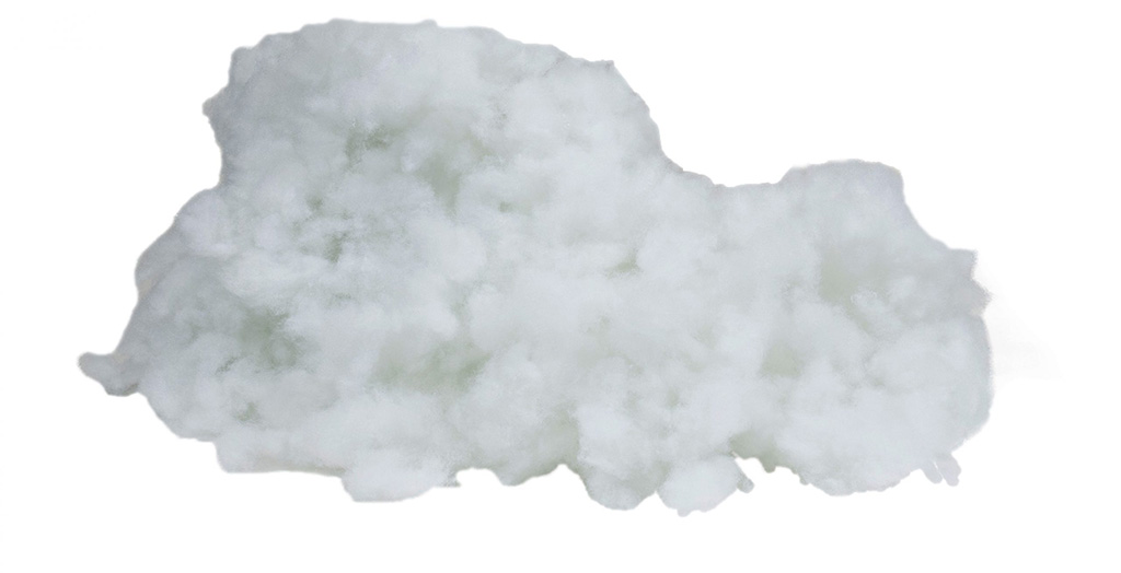 Close-up of soft white polyester fiberfill used as stuffing for plush toys, pillows, and cushions, showing its fluffy and lightweight texture.