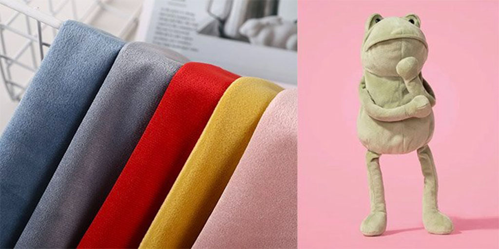 Soft velvet fabric in multiple colors beside a green plush frog toy on a pink background, showing texture and application of velvet in plush manufacturing.