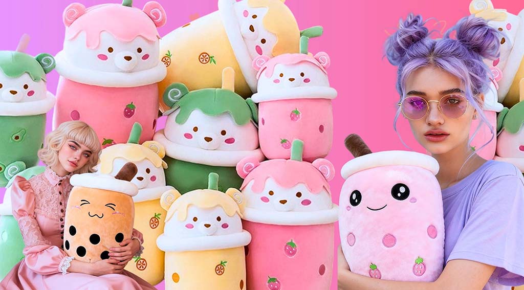 Colorful bubble tea plush toys in pastel pink, green, and yellow with smiling faces, held by two women dressed in kawaii-style outfits against a pink background.