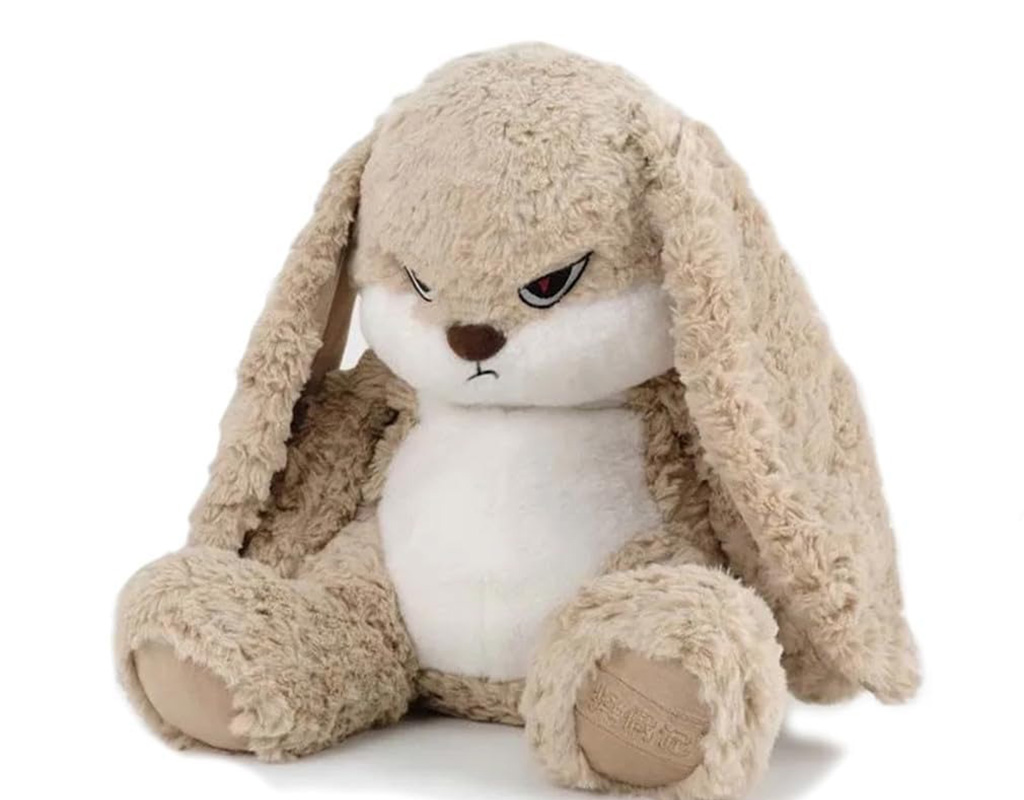 A beige plush bunny with long floppy ears and an angry facial expression, sitting upright on a white background.