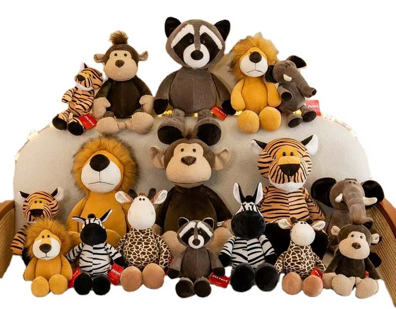 Large group of safari-themed stuffed animals—including lions, monkeys, raccoons, zebras, giraffes, tigers, and elephants—arranged together in a decorative display.