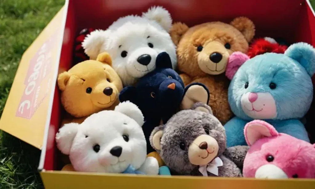 A box filled with colorful plush teddy bears of various sizes and shades, placed outdoors on green grass.