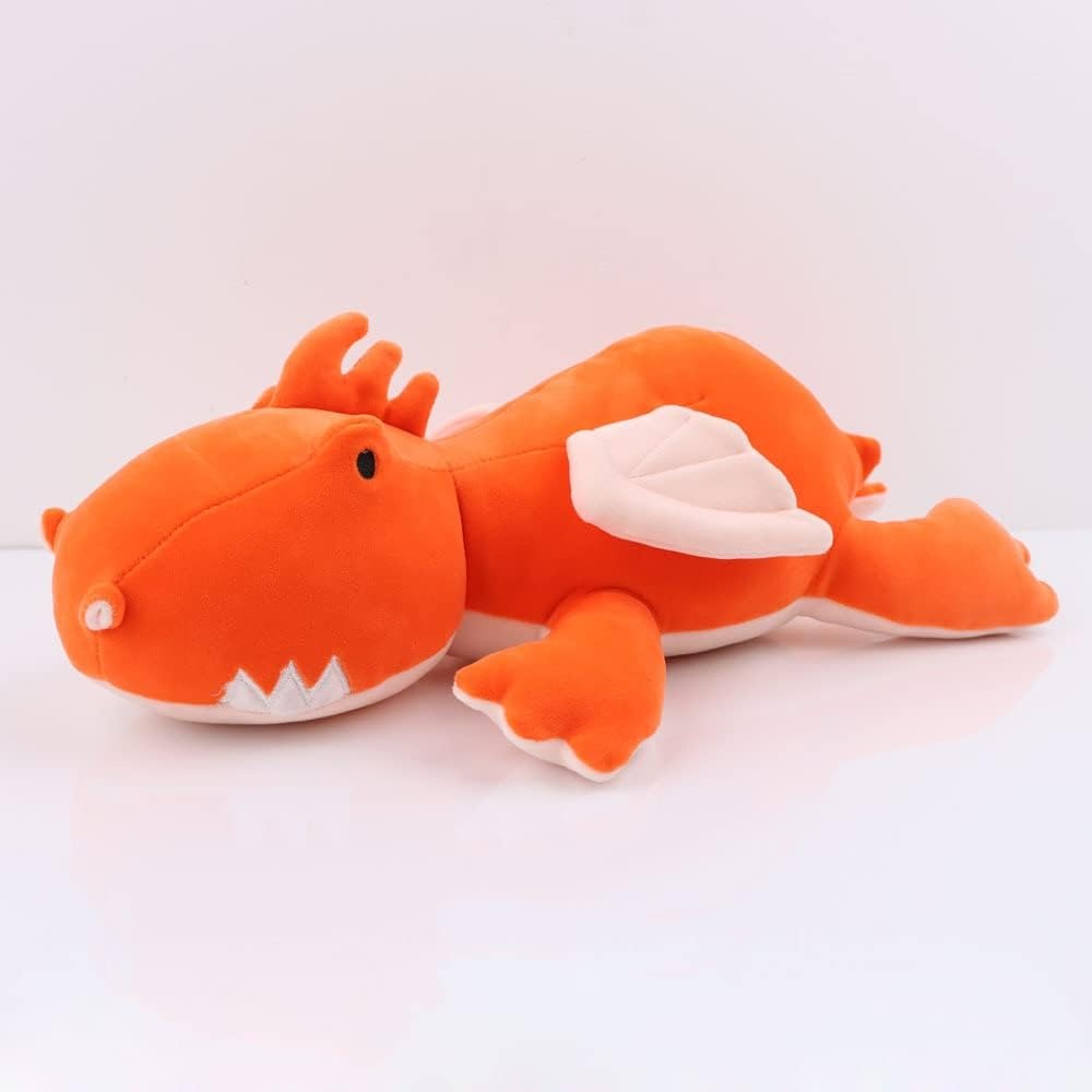 Cute orange dragon plush toy with white wings and embroidered facial details lying on a white background.