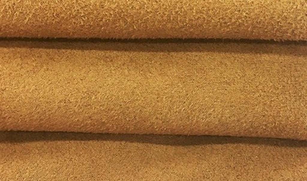 Close-up of light brown faux suede fabric showing its smooth, velvety surface and soft texture used for high-quality plush toys.